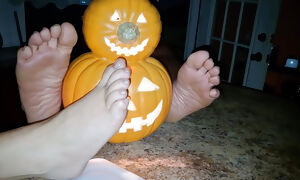 Demonstrating off our feet next to the pumpkin