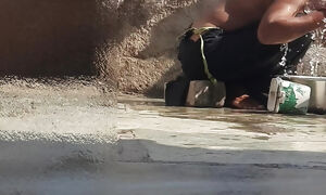 Indian sista is bathing in the open courtyard of the building, putting a finger in her burrow and massaging the assets, sista is washing the shower.